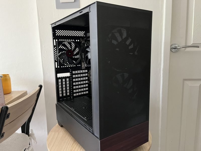 OakTower PC — front view showing mesh panel and wood-grain accent